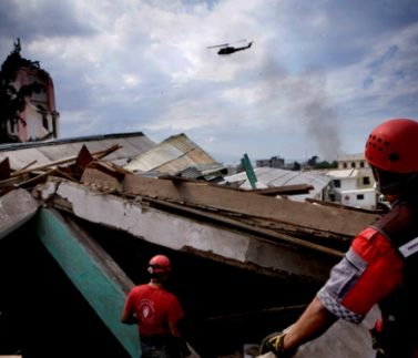 Search and Rescue teams the Cancun, Mexico Rescue Brigade and the South African Relief Team, working together under affiliation with Caritas Haiti, work to rescue a woman from a cathedral in the center of Port-au-Prince 6 days after the earthquake. Katie Orlinsky.